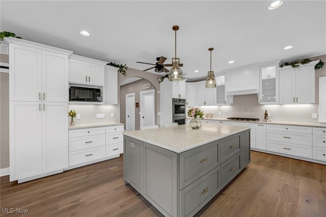 7440 Thatchum Ln, Concord, OH 44077 - kitchen with gray cabinets, black microwave, a ceiling fan, cooktop, and white cabinets