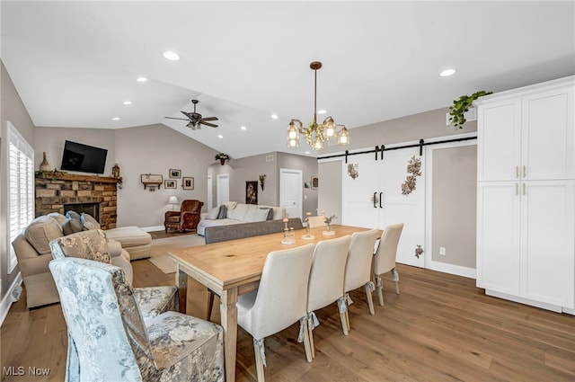 7440 Thatchum Ln, Concord, OH 44077 - dining area with light wood finished floors, a ceiling fan, a stone fireplace, lofted ceiling, and recessed lighting