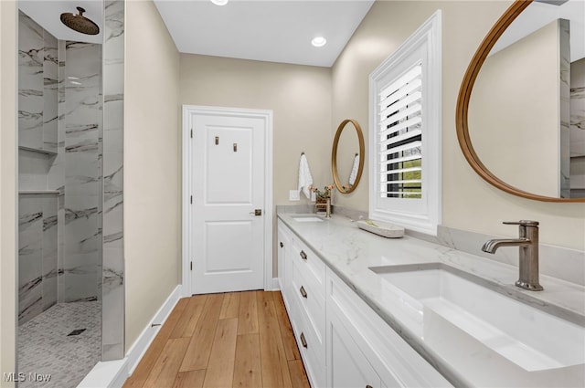 7440 Thatchum Ln, Concord, OH 44077 - full bathroom featuring wood finished floors, a walk in shower, recessed lighting, double vanity, and baseboards