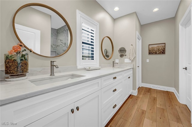 7440 Thatchum Ln, Concord, OH 44077 - bathroom with hardwood / wood-style flooring, double vanity, baseboards, and recessed lighting