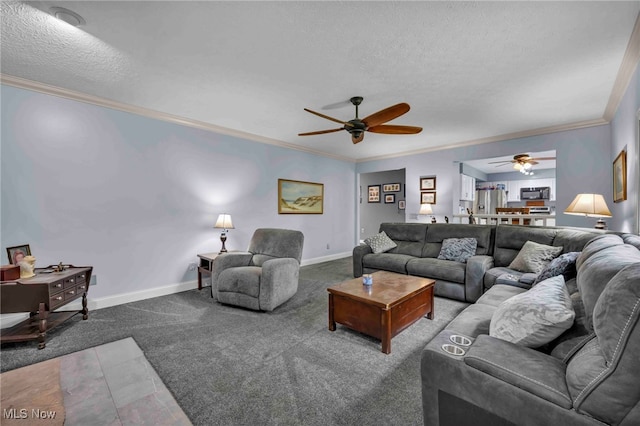 living room with a textured ceiling, a ceiling fan, carpet, ornamental molding, and baseboards