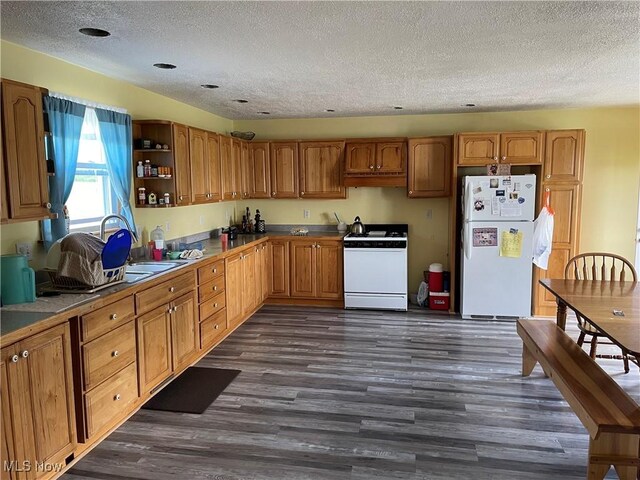 9207 Plank Rd, North Bloomfield, OH 44450 - kitchen featuring white appliances, a textured ceiling, dark wood-type flooring, open shelves, and brown cabinets