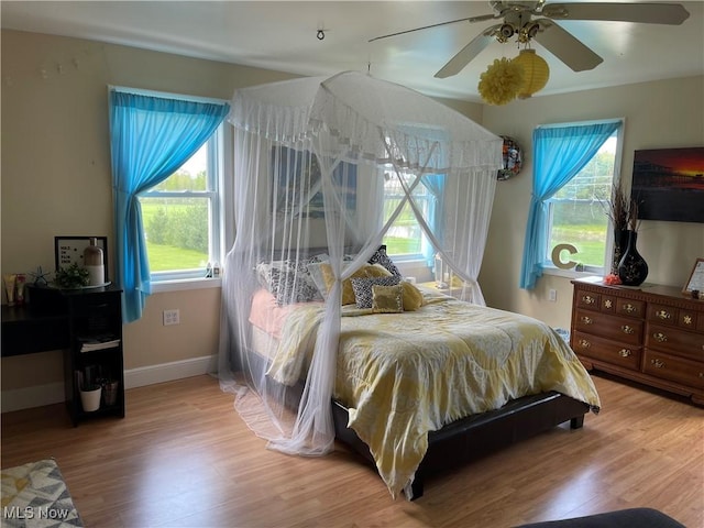 9207 Plank Rd, North Bloomfield, OH 44450 - bedroom with multiple windows, light wood finished floors, baseboards, and ceiling fan