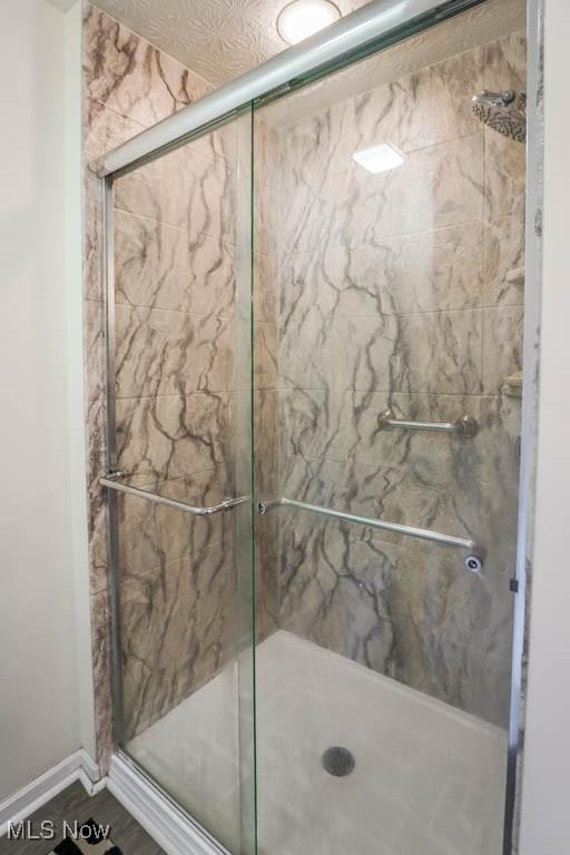 full bathroom featuring a shower stall