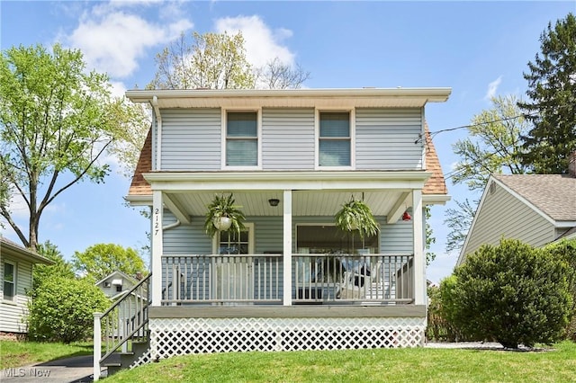back of house with covered porch and stairs