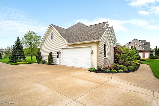 6972 Stagecoach Trl, Valley City, OH 44280 - view of home's exterior with driveway, roof with shingles, and a garage