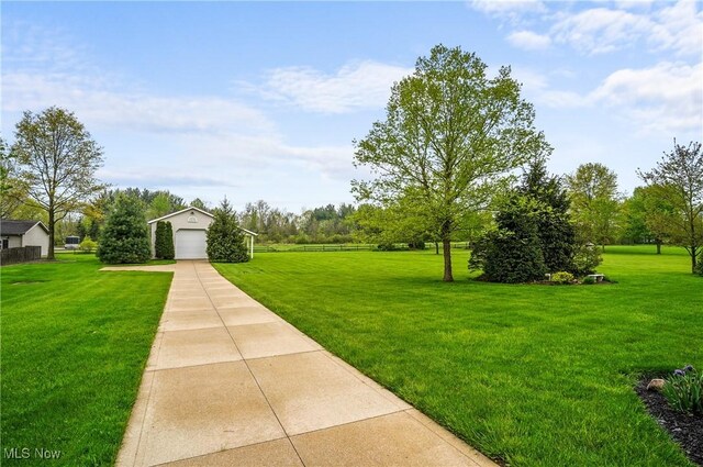 6972 Stagecoach Trl, Valley City, OH 44280 - view of green lawn featuring concrete driveway, an outbuilding, and a garage