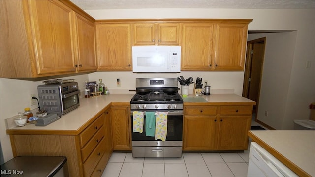 472 Vandalia Dr, Tallmadge, OH 44278 - kitchen with white appliances, light countertops, light tile patterned floors, and brown cabinets
