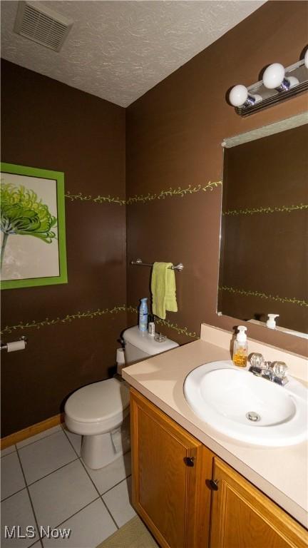 472 Vandalia Dr, Tallmadge, OH 44278 - half bathroom with vanity, tile patterned flooring, toilet, and a textured ceiling
