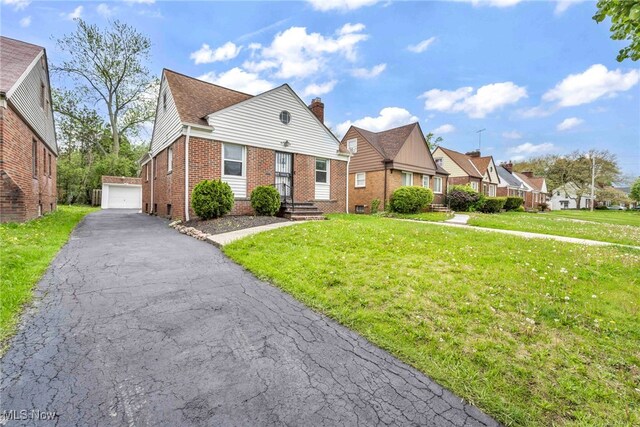 4110 Ellison Rd, South Euclid, OH 44121 - view of front of house featuring brick siding, a residential view, an outbuilding, and a front yard