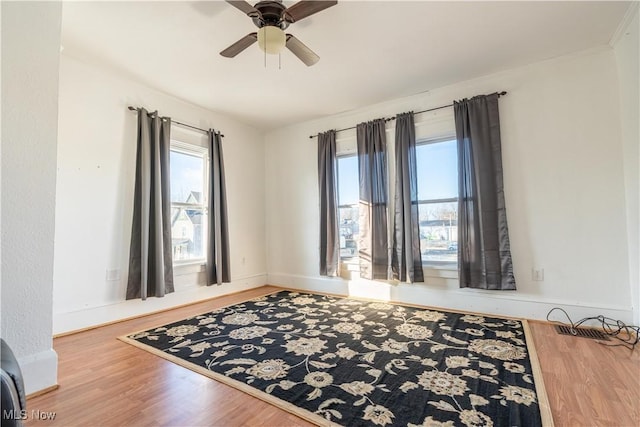 1016 12th St NE, Canton, OH 44704 - empty room featuring wood finished floors, ceiling fan, and baseboards