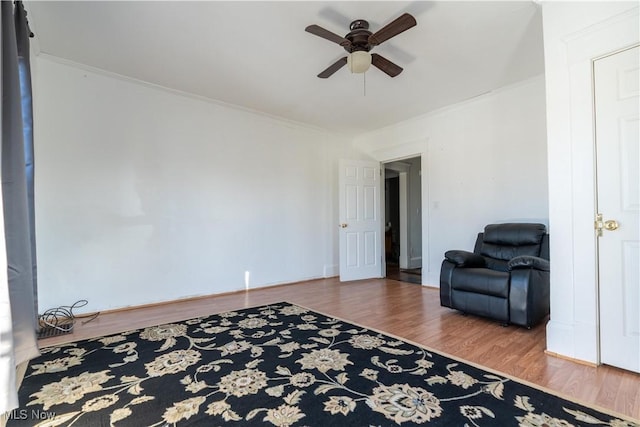 1016 12th St NE, Canton, OH 44704 - living area with a ceiling fan, wood finished floors, and crown molding