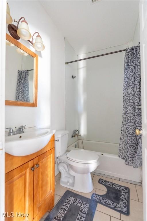 1016 12th St NE, Canton, OH 44704 - bathroom with tile patterned floors, toilet, shower / bath combo, and vanity