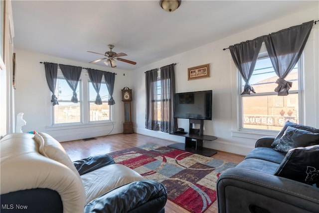 1016 12th St NE, Canton, OH 44704 - living room with healthy amount of natural light, wood finished floors, ceiling fan, and baseboards