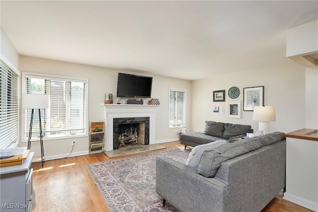 2530 Holgate Rd, Akron, OH 44313 - living room with a premium fireplace, light wood-style flooring, and baseboards