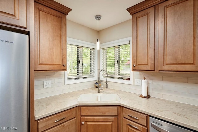2530 Holgate Rd, Akron, OH 44313 - kitchen featuring appliances with stainless steel finishes, a sink, backsplash, and pendant lighting