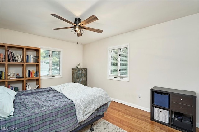 2530 Holgate Rd, Akron, OH 44313 - bedroom featuring multiple windows, wood finished floors, baseboards, and a ceiling fan
