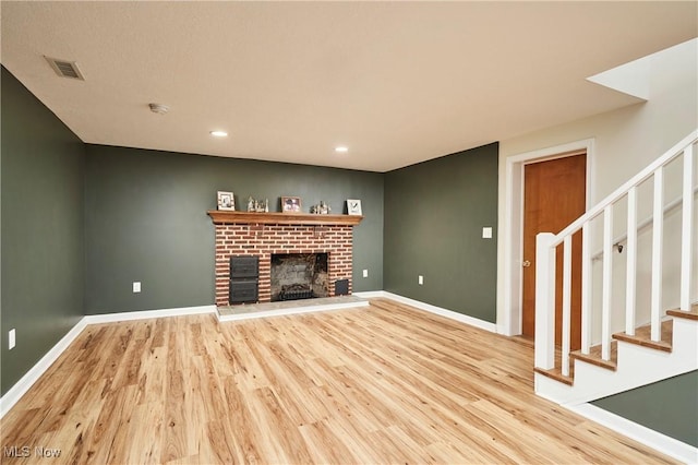 2530 Holgate Rd, Akron, OH 44313 - unfurnished living room with stairway, light wood-style floors, a brick fireplace, baseboards, and recessed lighting