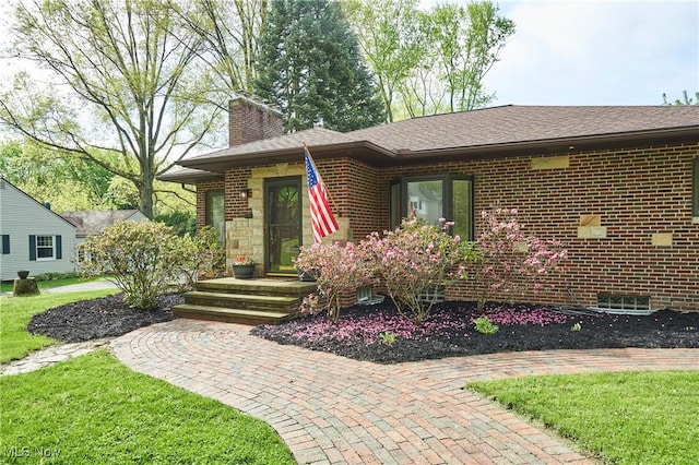 2530 Holgate Rd, Akron, OH 44313 - view of front of house featuring a chimney, brick siding, a front yard, and a shingled roof