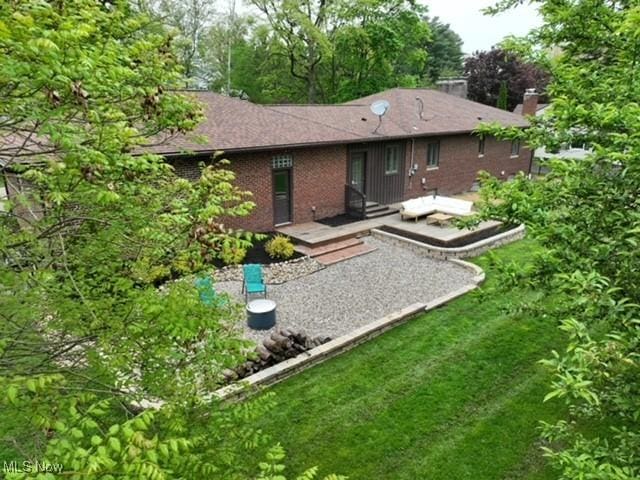 2530 Holgate Rd, Akron, OH 44313 - back of property with a wooden deck, brick siding, and a yard
