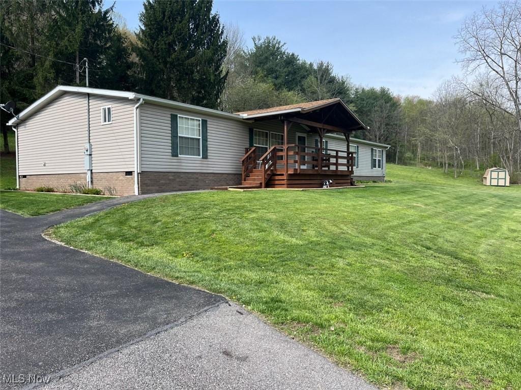 3737 Robertsville Ave SE, Minerva, OH 44657 - view of front of home with a front yard, crawl space, driveway, and a deck