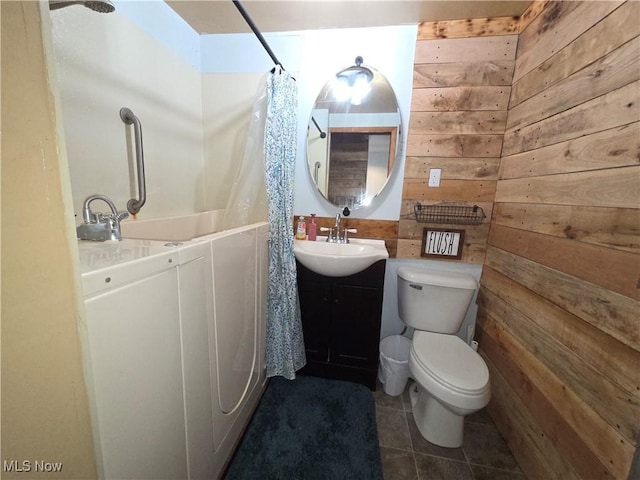 full bath featuring wood walls, tile patterned floors, toilet, vanity, and curtained shower