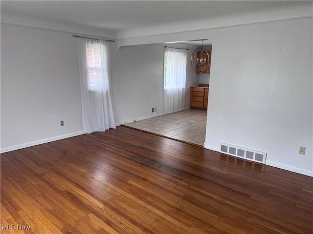 1422 Lorimer Rd, Parma, OH 44134 - unfurnished room featuring a chandelier, wood finished floors, and baseboards