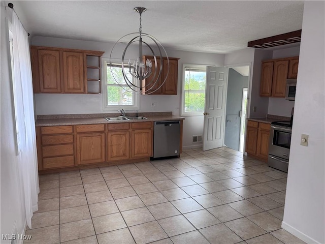 1422 Lorimer Rd, Parma, OH 44134 - kitchen with appliances with stainless steel finishes, a sink, a chandelier, brown cabinetry, and light tile patterned floors