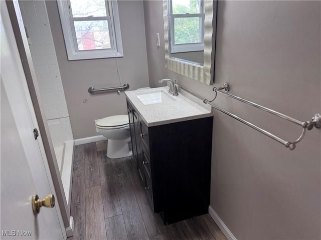 1422 Lorimer Rd, Parma, OH 44134 - full bath featuring vanity, wood finished floors, toilet, a shower, and baseboards