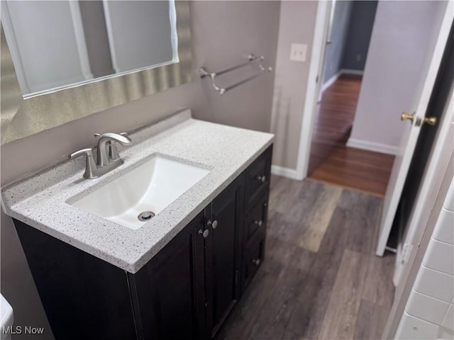 1422 Lorimer Rd, Parma, OH 44134 - bathroom with wood finished floors, vanity, and baseboards
