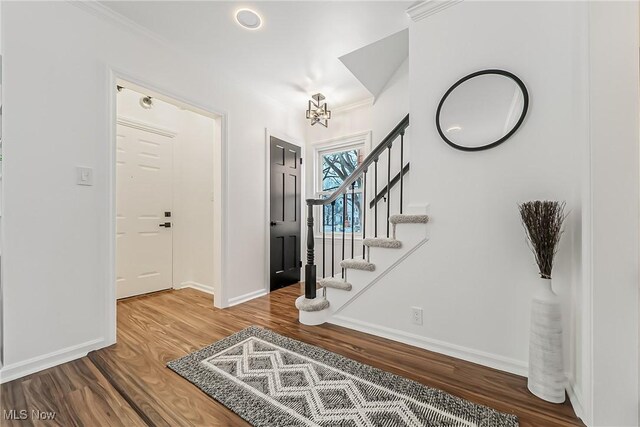 4073 Bushnell Rd, University Heights, OH 44118 - foyer entrance featuring baseboards, wood finished floors, stairs, and ornamental molding