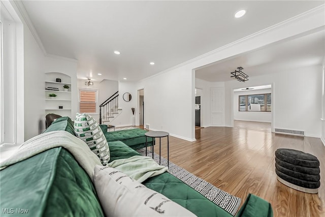 4073 Bushnell Rd, University Heights, OH 44118 - living area with stairway, wood finished floors, ornamental molding, recessed lighting, and baseboards