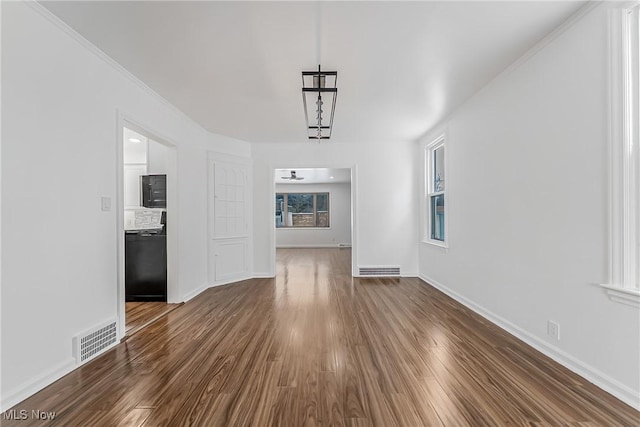 4073 Bushnell Rd, University Heights, OH 44118 - unfurnished dining area with dark wood-style flooring and baseboards