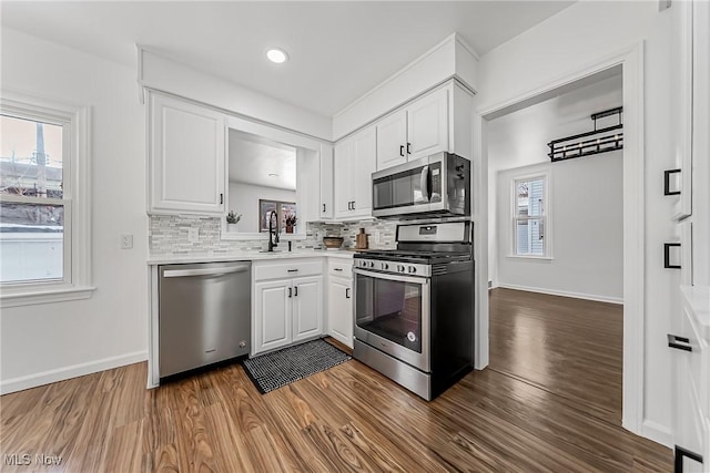 4073 Bushnell Rd, University Heights, OH 44118 - kitchen featuring stainless steel appliances, dark wood-style flooring, white cabinets, and recessed lighting