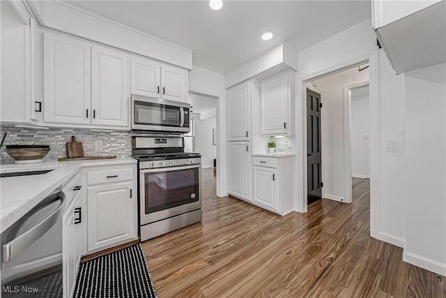 4073 Bushnell Rd, University Heights, OH 44118 - kitchen with stainless steel appliances, light wood-style flooring, white cabinets, light countertops, and recessed lighting
