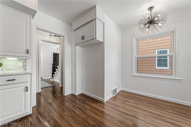 4073 Bushnell Rd, University Heights, OH 44118 - mudroom featuring a chandelier, dark wood-type flooring, and baseboards