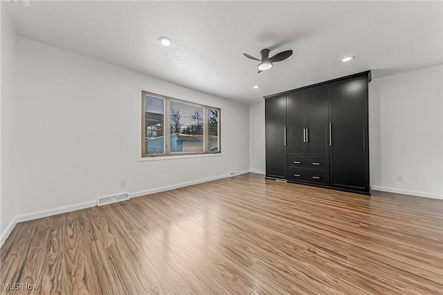 4073 Bushnell Rd, University Heights, OH 44118 - unfurnished bedroom featuring light wood-style floors, baseboards, recessed lighting, and a ceiling fan