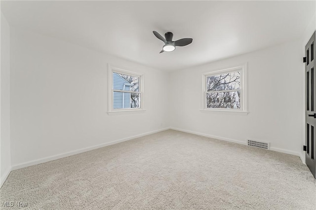4073 Bushnell Rd, University Heights, OH 44118 - carpeted spare room with healthy amount of natural light, a ceiling fan, and baseboards