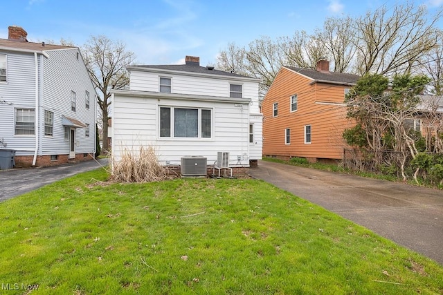 4073 Bushnell Rd, University Heights, OH 44118 - rear view of house with cooling unit, a yard, and a chimney