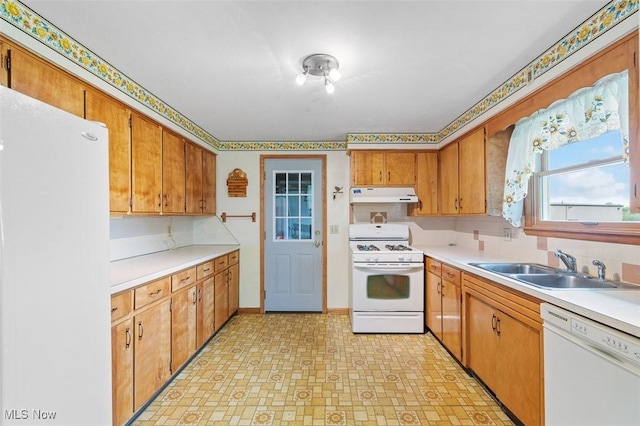 16139 E Main St, Mount Eaton, OH 44659 - kitchen with white appliances, under cabinet range hood, a sink, light flooring, and light countertops
