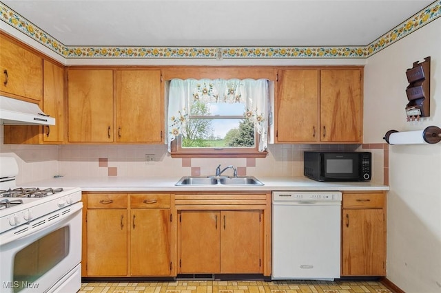 16139 E Main St, Mount Eaton, OH 44659 - kitchen featuring white appliances, a sink, under cabinet range hood, and light countertops