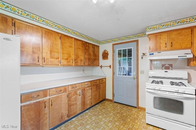 16139 E Main St, Mount Eaton, OH 44659 - kitchen featuring white appliances, under cabinet range hood, light countertops, and brown cabinets