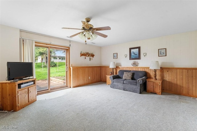 16139 E Main St, Mount Eaton, OH 44659 - carpeted living room featuring ceiling fan, wood walls, and wainscoting