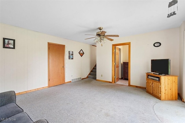 16139 E Main St, Mount Eaton, OH 44659 - unfurnished living room with stairs, a ceiling fan, light colored carpet, and baseboards