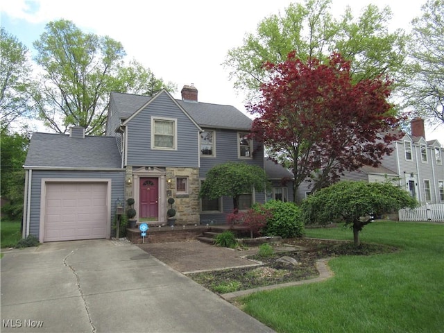 64 S Cadillac Dr, Boardman, OH 44512 - view of front of property featuring driveway, a garage, a front yard, a chimney, and stone siding