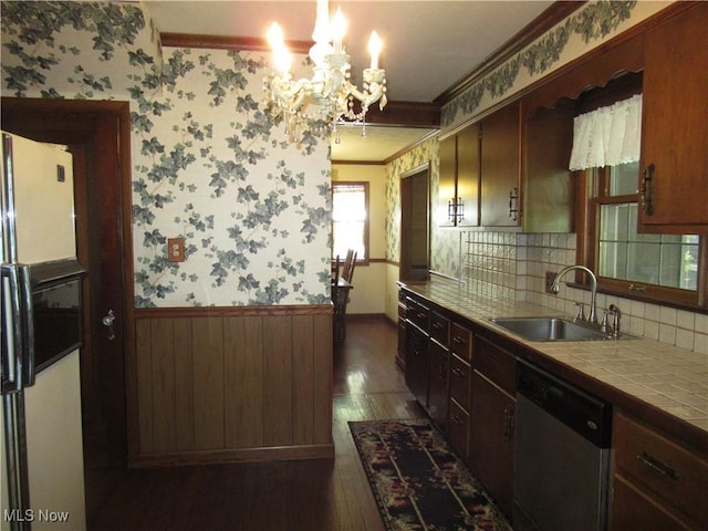 64 S Cadillac Dr, Boardman, OH 44512 - kitchen with dishwasher, white fridge with ice dispenser, wallpapered walls, tile countertops, and ornamental molding