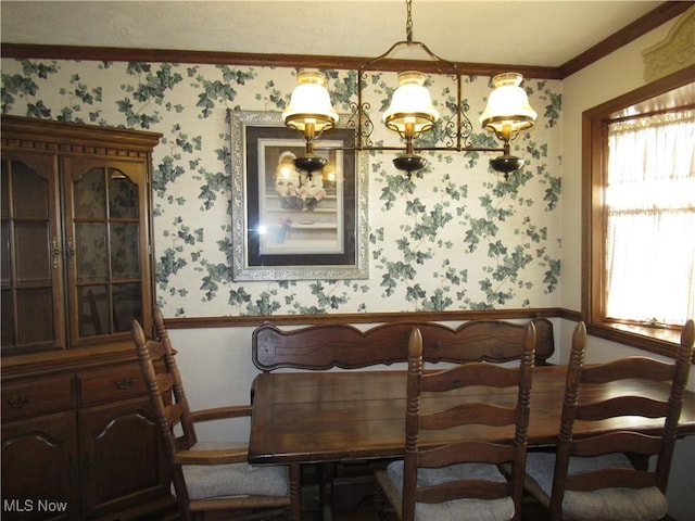 64 S Cadillac Dr, Boardman, OH 44512 - dining room featuring wallpapered walls, wainscoting, crown molding, and healthy amount of natural light