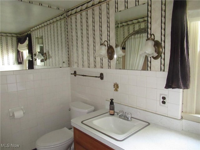 64 S Cadillac Dr, Boardman, OH 44512 - bathroom with toilet, tile walls, and vanity