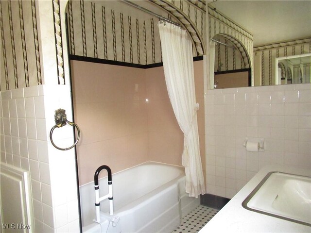 64 S Cadillac Dr, Boardman, OH 44512 - bathroom featuring tile walls, shower / tub combo, and a sink