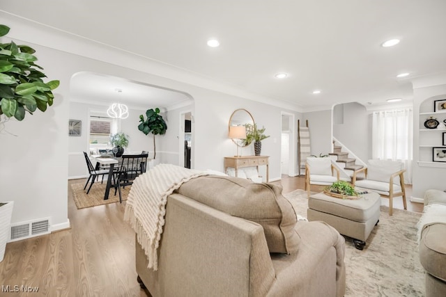 3843 Bendemeer Rd, Cleveland Heights, OH 44118 - living area with arched walkways, light wood finished floors, recessed lighting, baseboards, and ornamental molding